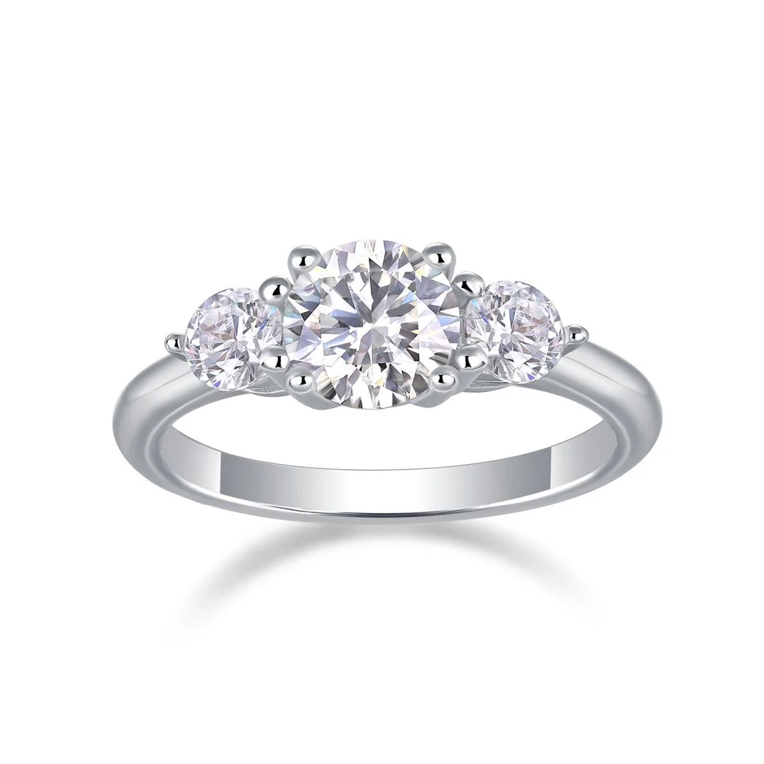 Round three-stone ring on a smooth band on a white background