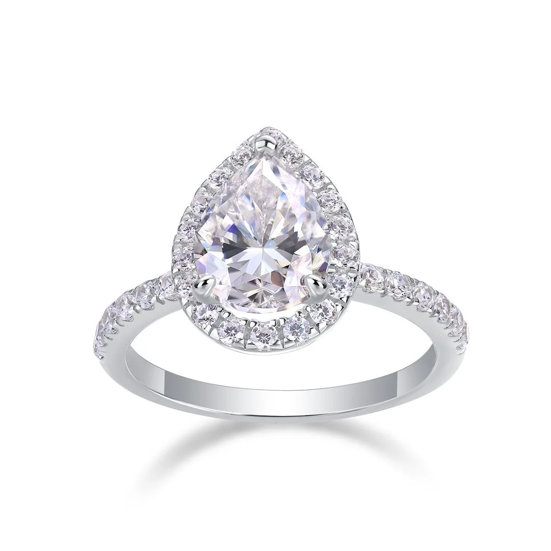 Pear halo ring with a stone-set band on a white background